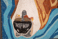 Intricate mosaic art featuring a black and white design amidst vibrant blue and earthy tones — showcasing detailed craftsmanship.