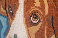 Intricate mosaic artwork featuring a close-up of a dog's face — warm brown and cream tiles create a lifelike expression.