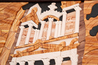 Intricate wooden puzzle featuring a classical architectural scene with detailed carvings and warm tones of natural wood.