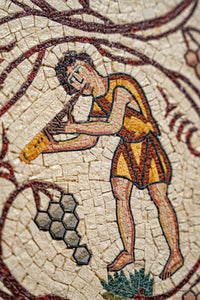 Intricate mosaic artwork depicting a musician playing a flute, featuring vibrant colors and detailed textures.