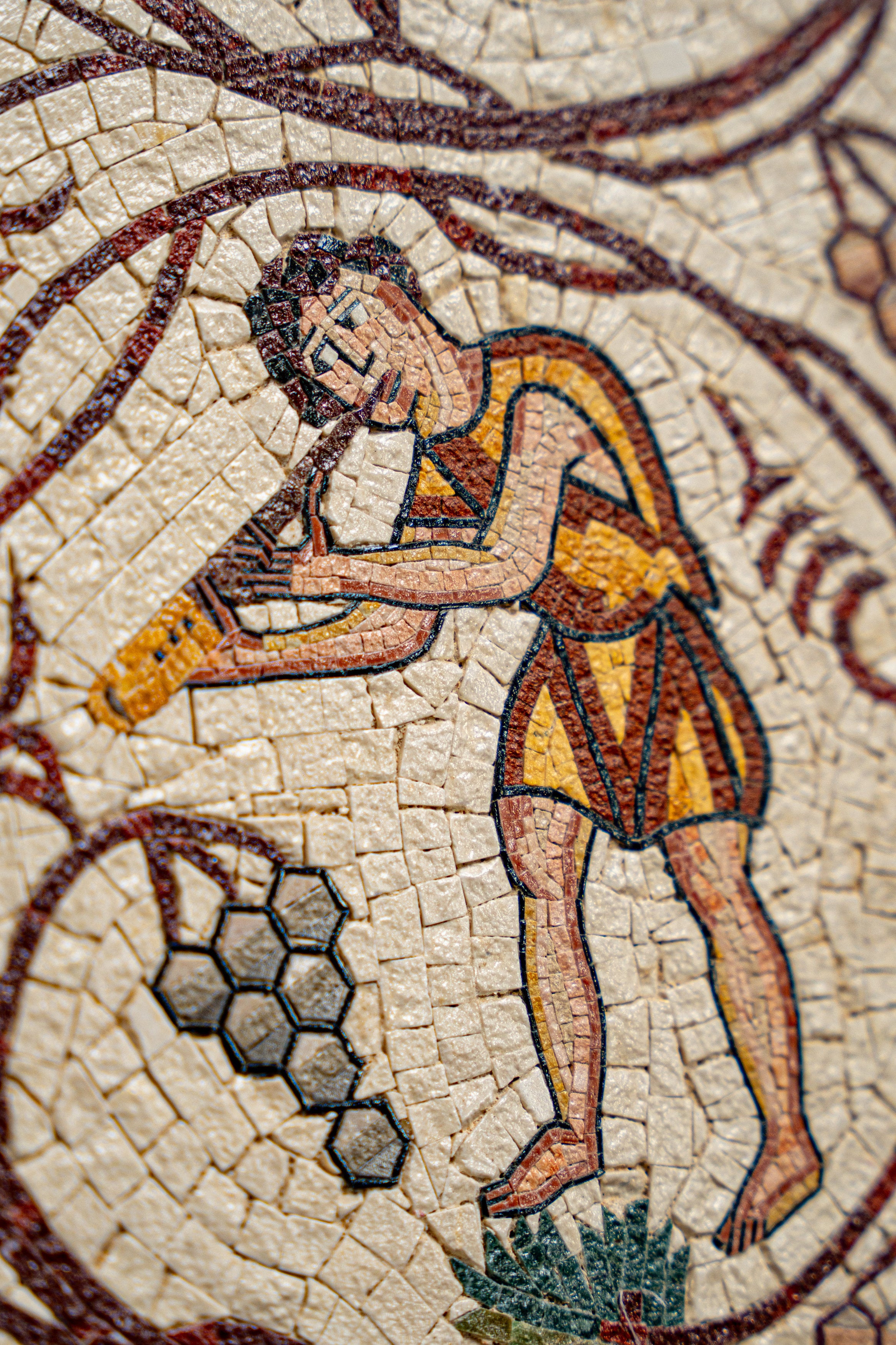 Intricate mosaic artwork depicting a musician playing a flute, featuring vibrant colors and detailed textures.
