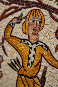 Vibrant mosaic depicting a figure in a yellow robe with intricate patterns — showcasing detailed craftsmanship and artistry.