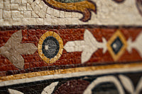 Intricate mosaic tile artwork featuring vibrant red, gold, and black patterns — showcasing detailed craftsmanship and texture