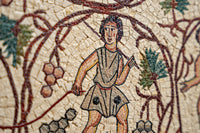 Intricate ancient mosaic artwork featuring a young figure in a tunic with detailed floral patterns and vibrant colors.
