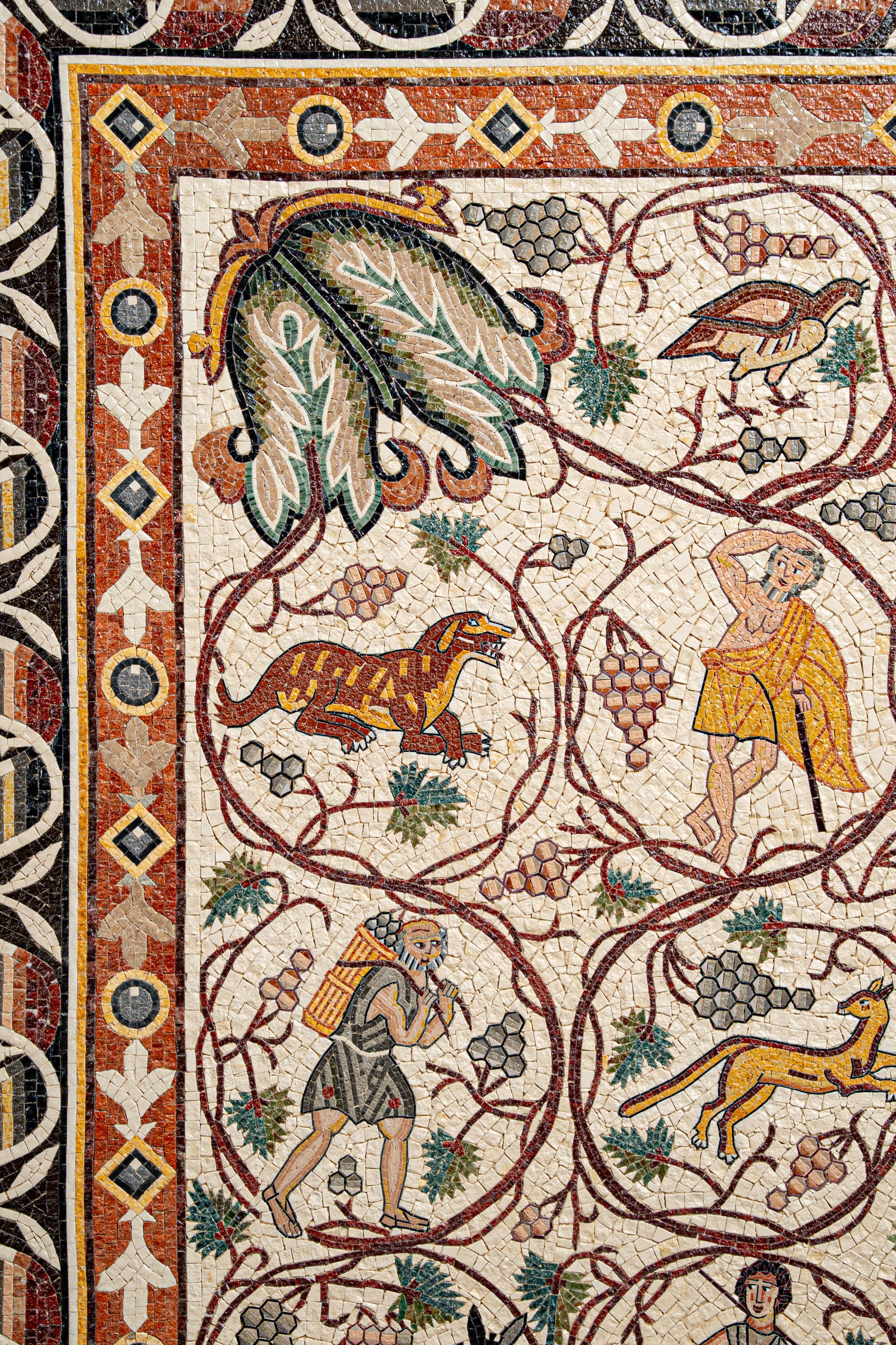 Intricate mosaic artwork featuring vibrant scenes of nature and mythology — detailed with rich colors and historical motifs