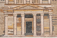 Intricate mosaic artwork depicting a classical building facade with detailed columns and a textured stone surface.