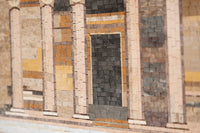 Intricate stone mosaic wall featuring warm earthy tones and textured tiles that create a stunning architectural design