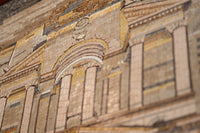 Intricate mosaic art featuring classical architecture with warm beige and golden tones — showcasing detailed craftsmanship in tile work.