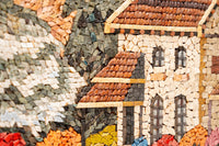 Intricate mosaic art featuring a charming cottage with textured tiles in earthy tones and vibrant accents — a stunning handcrafted piece.