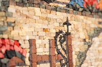 Intricate mosaic artwork featuring colorful stone tiles in a heart design — a vibrant display of craftsmanship and detail