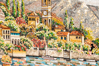 Intricate mosaic artwork depicting a vibrant lakeside village with colorful buildings and lush greenery under soft sunlight.