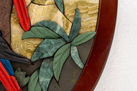 Intricate mosaic wall art featuring vibrant red and blue accents with lush green leaves and a polished wooden frame