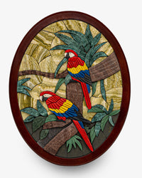 Vibrant decorative wall art featuring two colorful parrots perched on a branch amidst lush green foliage — intricately crafted with natural stone.
