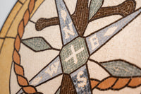 Intricate mosaic compass design featuring directional symbols in earthy tones and textured tiles for a vintage appeal