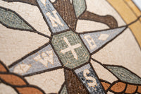 Intricate compass rose mosaic featuring earthy tones and detailed textures — a beautiful blend of craftsmanship and artistry