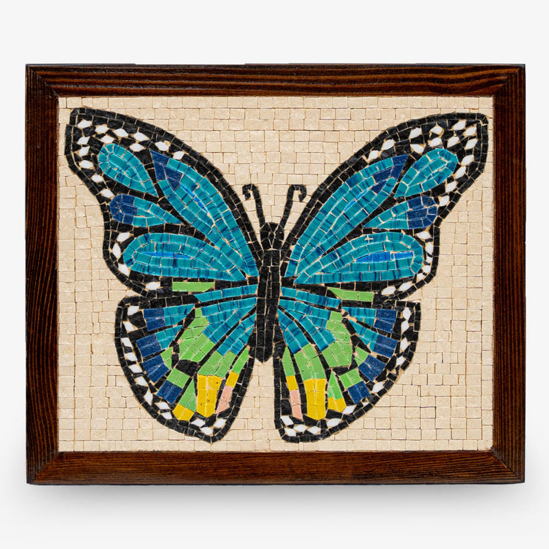 Colorful mosaic butterfly wall art featuring vibrant blue and green tiles set in a dark wooden frame
