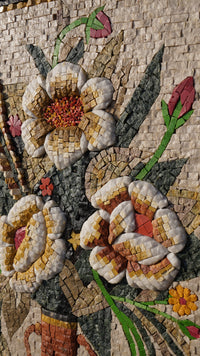 Intricate floral mosaic art featuring textured petals in warm tones of cream, gold, and red against a natural backdrop.