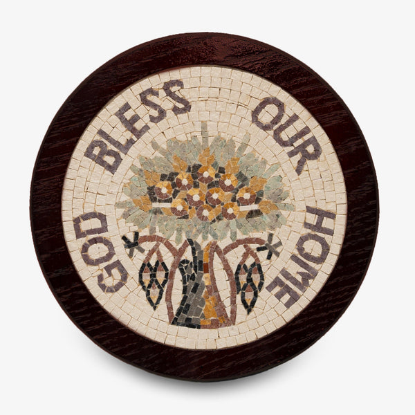 Artistic mosaic plaque featuring a floral design with the words 'Bless Our Home' encircled in earthy tones on a wooden base