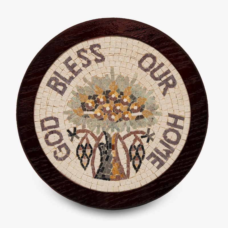 Artistic mosaic plaque featuring a floral design with the words 'Bless Our Home' encircled in earthy tones on a wooden base