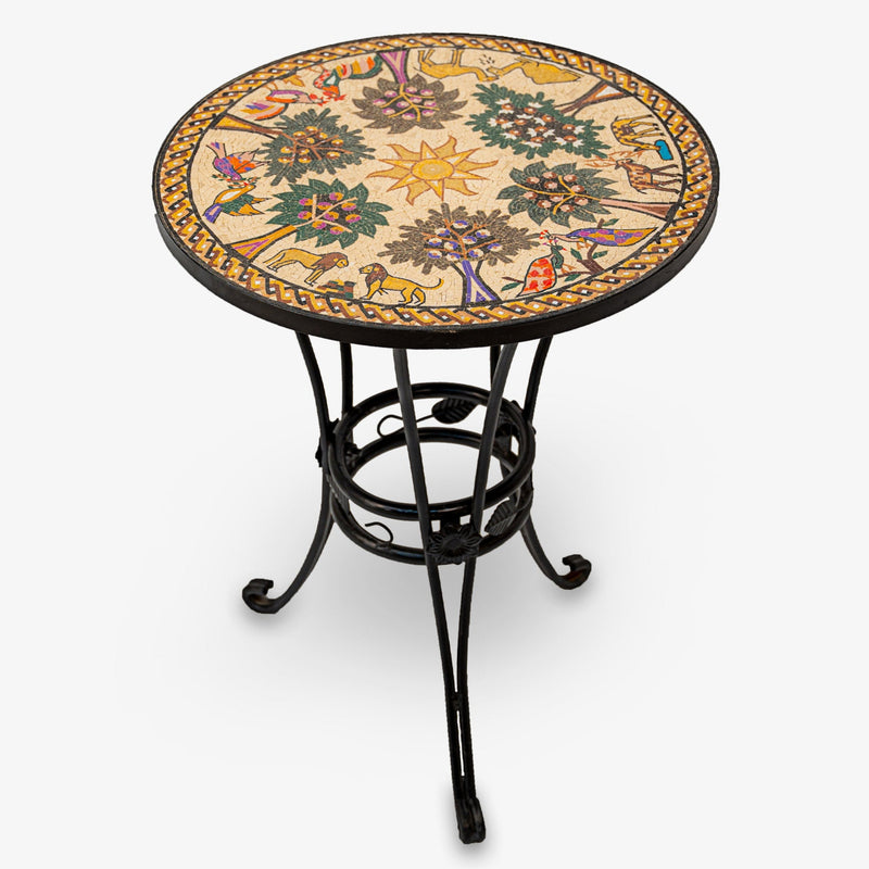Intricate mosaic side table with a colorful floral design on a round top, supported by a sturdy black wrought iron base.