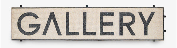 Wooden sign with 'GALLERY' text on a white background