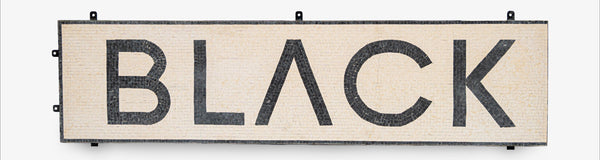 Decorative sign with the word 'BLACK' on a white background