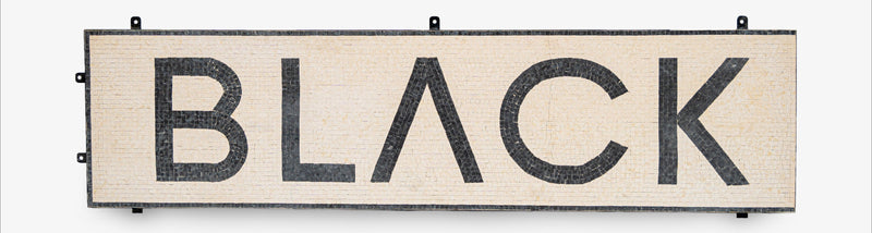 Decorative sign with the word 'BLACK' on a white background