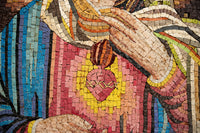 Vibrant mosaic art featuring a heart-shaped pendant in rich colors — intricate detailing on a textured surface