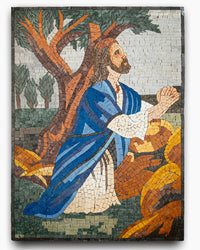 Vibrant mosaic artwork depicting a praying figure in a blue robe with intricate tile details against a natural backdrop.