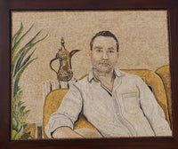 Intricate mosaic artwork depicting a man seated on a golden sofa with a traditional coffee pot in the background