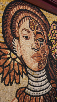 Intricate mosaic artwork featuring a woman's face with detailed patterns and vibrant colors, showcasing artistic craftsmanship.