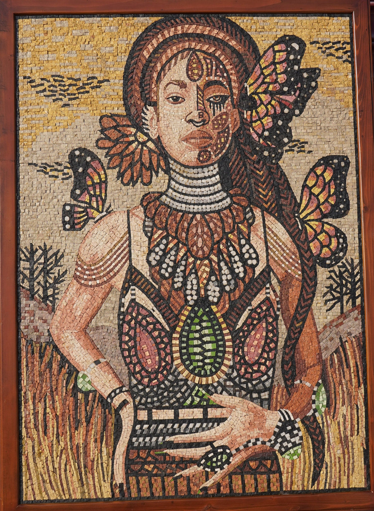 Intricate mosaic art featuring a woman adorned with colorful butterfly motifs and detailed tribal patterns in earthy tones.