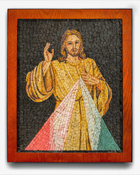 Intricate mosaic artwork depicting a figure in a flowing robe with vibrant red and green rays — framed in rich wooden borders.