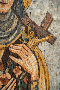 Intricate mosaic artwork featuring a figure holding a small cross — vibrant tiles in earthy tones create depth and texture.