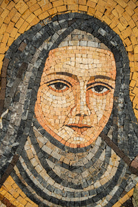 Intricate mosaic artwork depicting a serene woman with a detailed expression — crafted from natural stone tiles in warm hues.