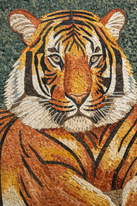 Intricate mosaic artwork depicting a tiger's face with vibrant orange and black tiles against a textured green background
