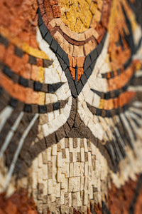Intricate mosaic artwork featuring warm earth tones and detailed textures — a stunning display of craftsmanship and design.
