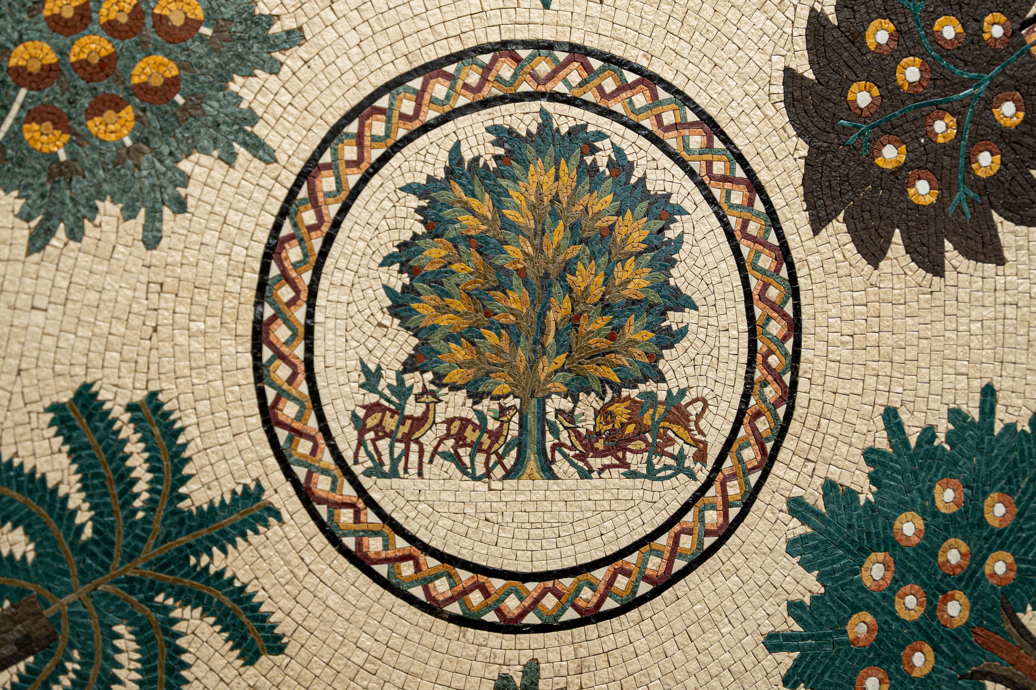 Intricate mosaic art featuring a vibrant tree surrounded by detailed flora — a stunning example of classical craftsmanship.