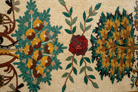 Intricate mosaic wall art featuring vibrant floral patterns in rich reds, greens, and yellows against a textured background