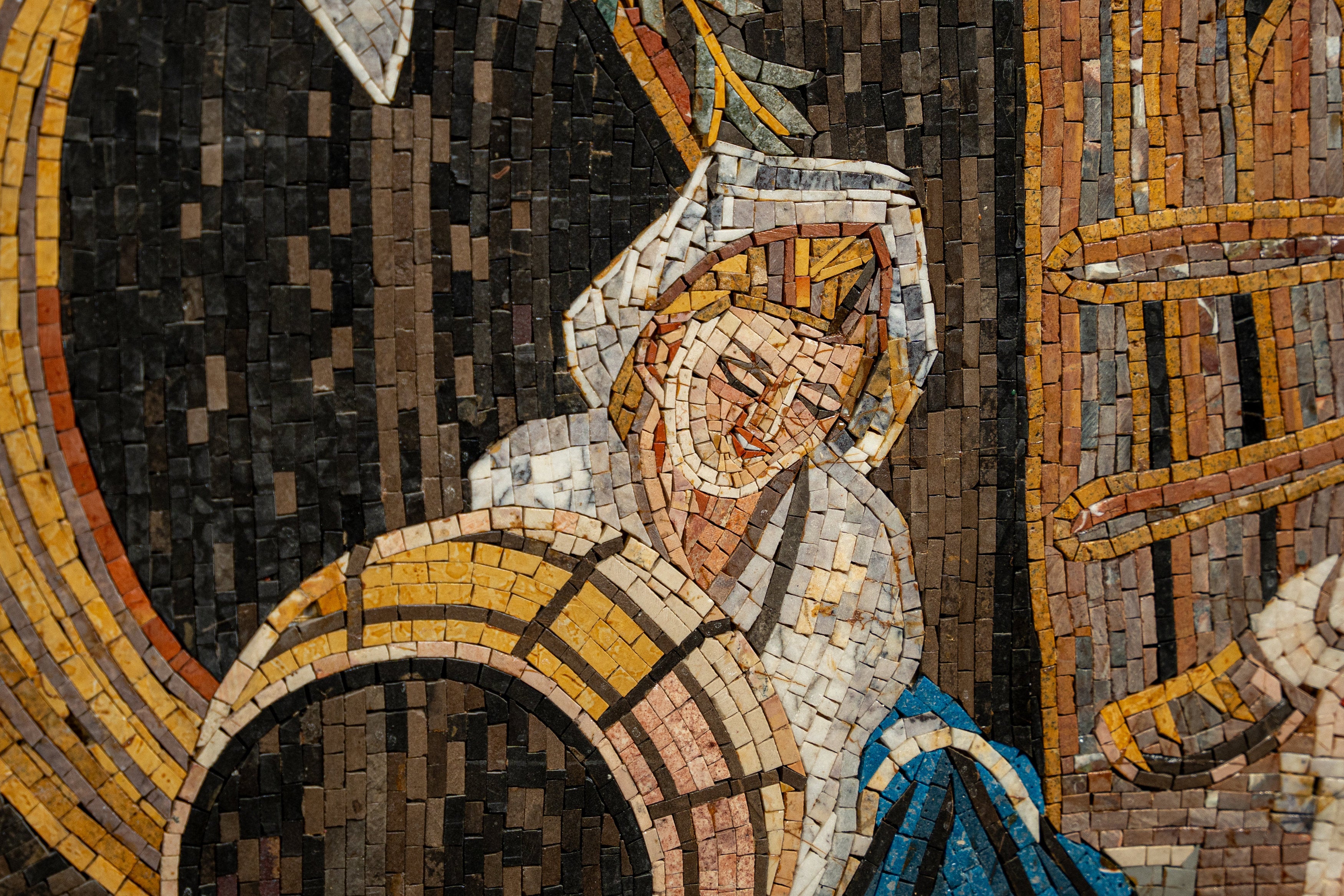 Intricate mosaic artwork featuring a smiling figure with golden hair and blue garments, showcasing detailed craftsmanship.