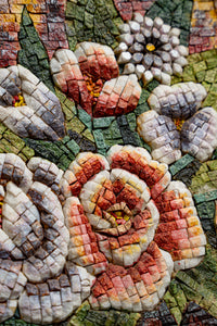 Intricate floral mosaic artwork featuring textured petals in vibrant shades of red, green, and cream with detailed craftsmanship