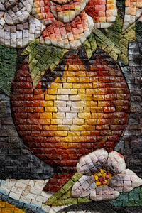 Intricate mosaic art featuring a vibrant red and orange vase surrounded by delicate flowers, showcasing detailed craftsmanship.