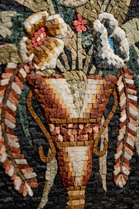 Intricate floral mosaic art featuring a vibrant vase crafted from natural stone pieces, showcasing rich textures and colors.