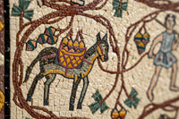 Intricate mosaic art featuring a black horse adorned with a colorful basket, surrounded by detailed vines and figures.