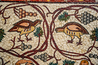 Intricate mosaic featuring colorful birds surrounded by vines and grapes — a detailed representation of ancient artistry.