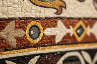Intricate mosaic tile design featuring earthy tones of terracotta and cream with a glossy finish — showcasing detailed craftsmanship.