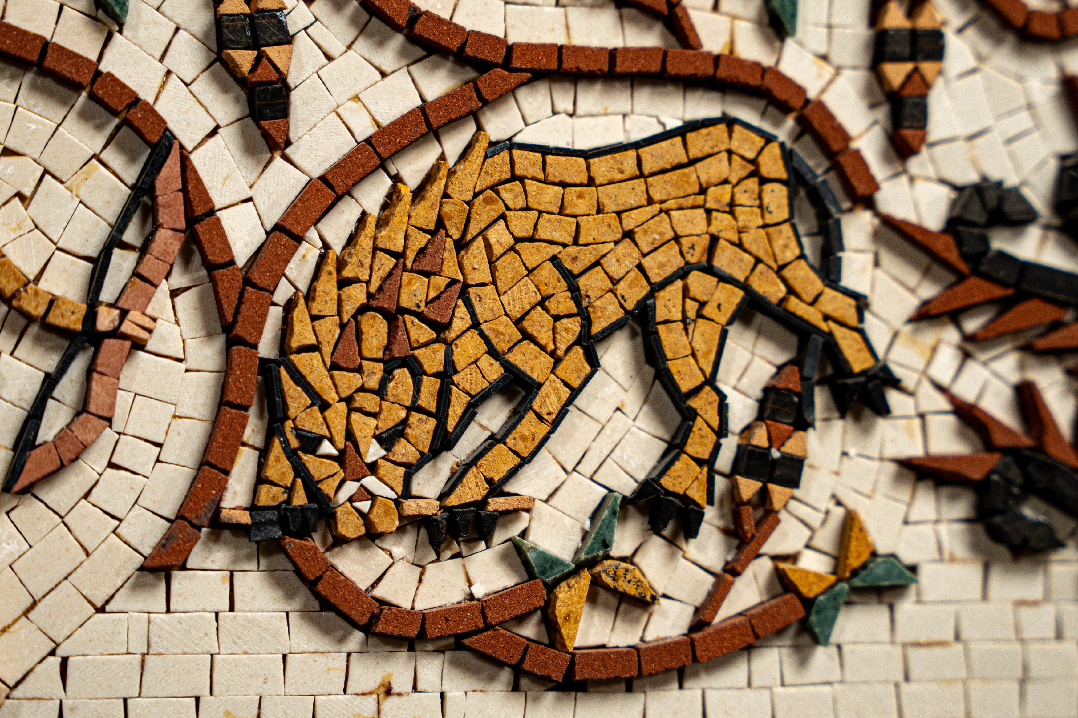 Intricate mosaic art featuring a stylized lion in earthy tones — crafted with small, colorful tiles for a textured finish