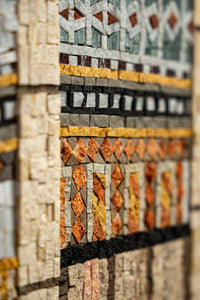 Intricate mosaic wall art featuring natural stone tiles in earthy tones — a captivating blend of texture and color.