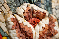 Intricate mosaic art featuring vibrant red and orange tiles with textured surfaces — a stunning decorative piece for any space.