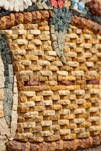 Intricate mosaic wall art featuring a textured design in warm earth tones — crafted from natural stone tiles.